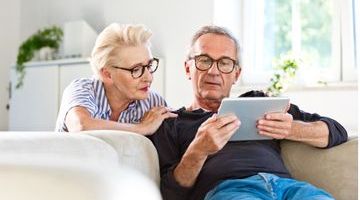 senior-couple-watching-digital-tablet-together-at-home-picture-id1219364296 (1).jpg