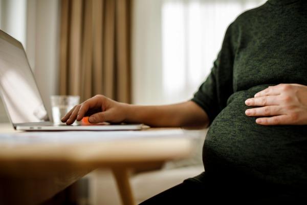 Pregnant self-employed woman working from home