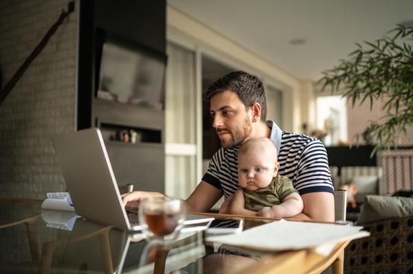 self-employed dad working from home with small child